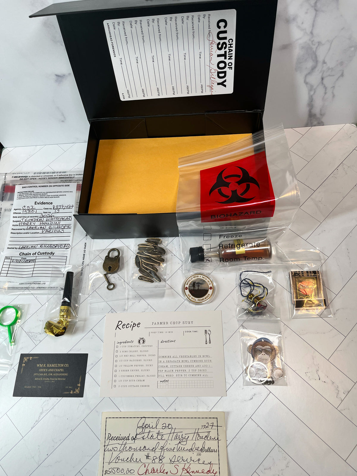 The actual Murder Box contents laid out alongside the open box